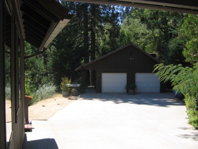 View of the garage and hot tub from the carport